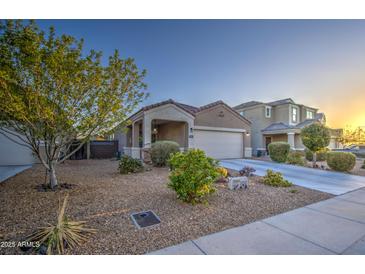 Charming single-story home featuring a two-car garage and desert landscaping at 30945 W Picadilly Rd, Buckeye, AZ 85396