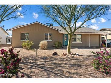 Charming single-story home with desert landscaping and a pop of color from the turquoise front door at 3342 N 63Rd Ave, Phoenix, AZ 85033