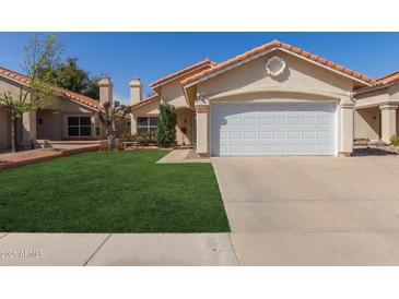 Charming single-story home with a well-manicured lawn and a two-car garage at 6834 S Dennis Dr, Tempe, AZ 85283