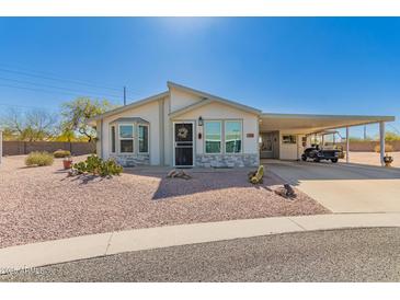 Charming single-story home features a covered carport and low maintenance desert landscaping at 8500 E Southern Ave # 551, Mesa, AZ 85209