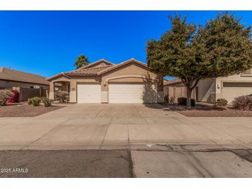 Charming single-story home featuring a well-maintained front yard and a convenient two-car garage at 12622 W Apodaca Dr, Litchfield Park, AZ 85340