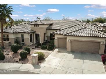 Charming single-story home with a well-manicured front yard and a spacious three-car garage at 16769 W Brookhaven Ct, Surprise, AZ 85387