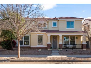 Charming two-story home with well-maintained landscaping, inviting porch, and neutral color scheme at 1893 S Sinova S Ave, Gilbert, AZ 85295