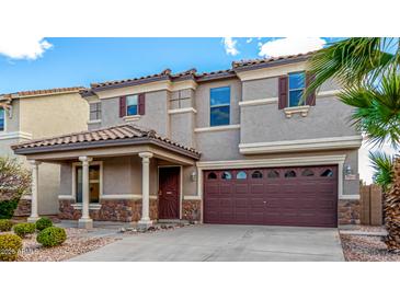 Charming two-story home with desert landscaping, covered entry, and an attached two-car garage at 25845 W Lynne Ln, Buckeye, AZ 85326