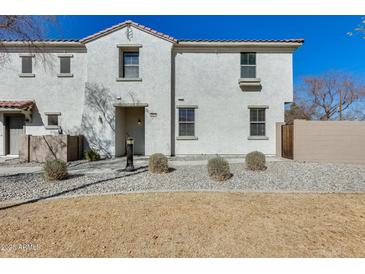 Charming two-story townhouse with neutral stucco and low-maintenance desert landscaping out front at 2868 E Dunbar Dr, Phoenix, AZ 85042