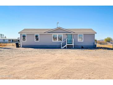 Charming single-story home featuring a covered entryway and well-maintained facade at 38203 W Willetta St, Tonopah, AZ 85354