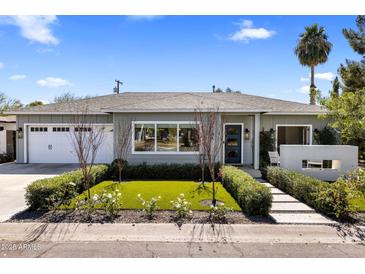 Charming single-story home with a well-manicured front yard and inviting entryway at 4119 E Indianola Ave, Phoenix, AZ 85018