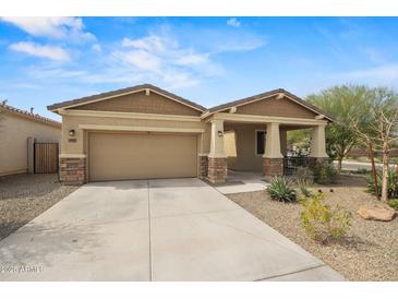 Charming single-story home featuring a covered front porch and low-maintenance desert landscaping at 4708 S 117Th Ave, Avondale, AZ 85323