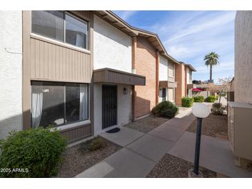 View of multi-Gathering exterior with neutral colors, brick accents, and well maintained landscaping at 5106 N 17Th Ave # 3, Phoenix, AZ 85015