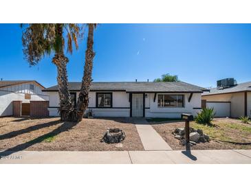 Charming single-story home featuring a low-maintenance yard and palm trees at 5327 W Saint Moritz Ln, Glendale, AZ 85306