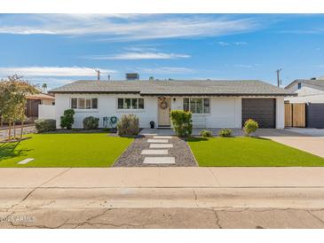 Charming single-story home with manicured lawn, and neutral paint at 7531 E Belleview St, Scottsdale, AZ 85257