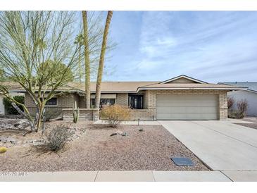 Charming single-story brick home featuring a well-kept front yard with desert landscaping and a two-car garage at 7629 N Via De La Campana --, Scottsdale, AZ 85258