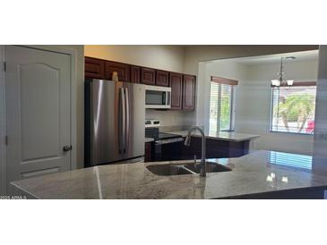 Bright kitchen featuring stainless appliances, granite countertops and a convenient breakfast bar at 9121 W Alvarado St, Phoenix, AZ 85037
