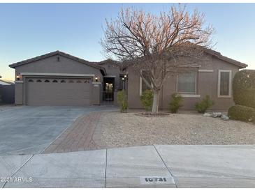 Charming single-story home with a well-manicured yard and covered entryway at 10731 W Wikieup Ln, Peoria, AZ 85373