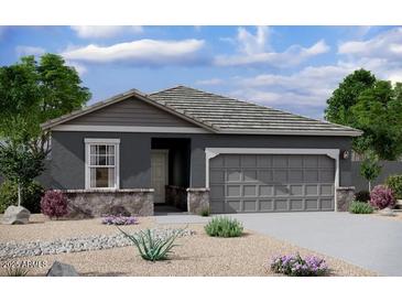 Charming single-story home featuring stone accents, a two-car garage, and low maintenance desert landscaping at 15657 W Deanne Dr, Waddell, AZ 85355