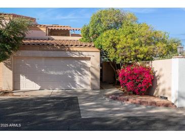 Charming home featuring an attached garage, mature landscaping, and a welcoming desert aesthetic at 1920 E Maryland Ave # 16, Phoenix, AZ 85016