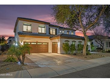 Elegant two-story home with a three-car garage and well-manicured landscaping at 2454 E Ebony Dr, Chandler, AZ 85286