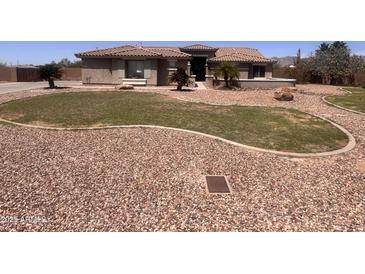 Charming single-story home with desert landscaping and a circular driveway provides plenty of curb appeal at 3608 N Mansfield Dr, Litchfield Park, AZ 85340