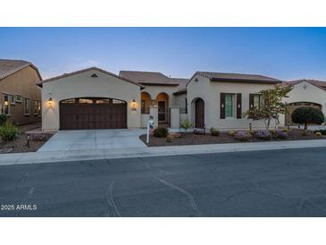 Charming single-story home boasts a gated entrance, manicured landscaping, and a two-car garage at 36276 N Secret Garden Path, Queen Creek, AZ 85140