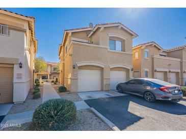 Charming two-story townhome with a two-car garage and a well-maintained front yard at 525 N Miller Rd # 122, Scottsdale, AZ 85257