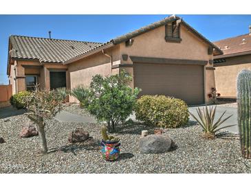 Single level home with desert landscaping, gravel, and a two car garage at 8176 S Pioneer Ct, Gold Canyon, AZ 85118