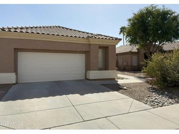 A well-maintained home with a two-car garage and desert landscaping at 901 W Oriole Way, Chandler, AZ 85286