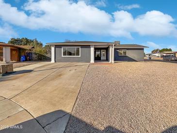 Charming single-story home featuring a long driveway and low maintenance desert landscaping at 909 W Danbury Rd, Phoenix, AZ 85023