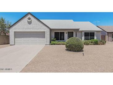 Charming single-story home with a well-maintained lawn and an attached two-car garage at 1016 E Utopia Rd, Phoenix, AZ 85024