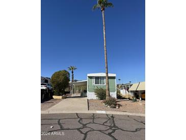 Charming exterior of a one-story home with a carport, easy access parking, and green accents at 12814 N 19Th Pl # 19, Phoenix, AZ 85022