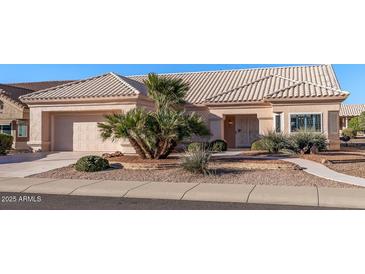 Inviting single story home with desert landscaping, tile roof, and attached two car garage at 14218 W Via Tercero --, Sun City West, AZ 85375