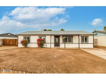 Charming single-story home with a minimalist desert landscape and a covered entry way at 14436 N 34Th Pl, Phoenix, AZ 85032