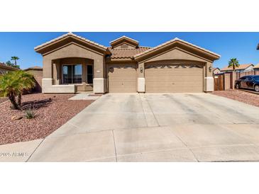 Charming single story home with a two car garage and well maintained desert landscaping at 14846 N 145Th Ave, Surprise, AZ 85379