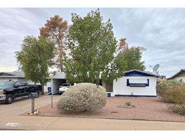Charming single-story home featuring a well-maintained yard and an attached carport at 1508 S Grand Dr, Apache Junction, AZ 85120