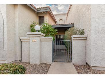 Charming courtyard entrance with secure gate and meticulously maintained stucco facade at 1718 S Longmore -- # 41, Mesa, AZ 85202