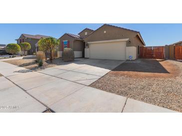 Charming one-story home features a two car garage, desert landscaping, and a cozy front porch at 17583 W Paraiso Dr, Surprise, AZ 85387