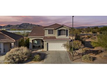 Charming two-story home featuring a well-manicured front yard and a two-car garage at 1812 W Kuralt Dr, Anthem, AZ 85086