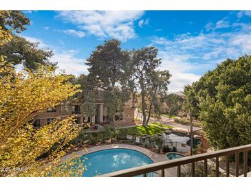 Inviting community pool and spa, surrounded by lush landscaping, provide a resort-style living experience at 2989 N 44Th St # 3016, Phoenix, AZ 85018