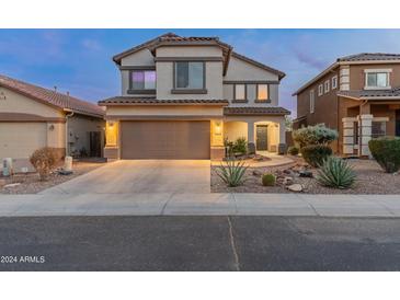 Two-story home featuring a tidy desert rock garden, a two-car garage, and well-kept landscaping at 4535 W Cottontail Rd, Phoenix, AZ 85086