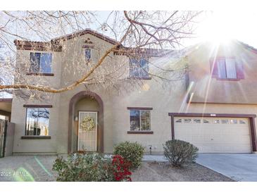 Charming two-story home with landscaped yard, archway entrance, and a two car garage at 1349 E Dunbar Dr, Phoenix, AZ 85042