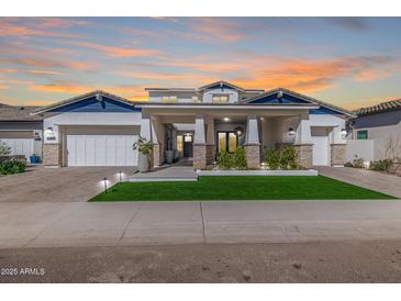 Stunning two-story home with a well-manicured lawn, a three-car garage, and desert landscaping at 17336 W Crawfordsville Dr, Surprise, AZ 85388