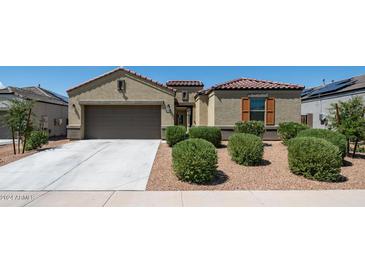 Inviting single-story home featuring a two-car garage, neutral stucco, and well-manicured landscaping at 30324 W Crittenden Ln, Buckeye, AZ 85396