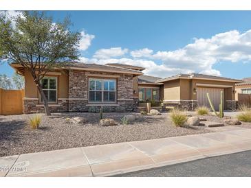 Charming home featuring desert landscaping, stone accents, and a two-car garage at 31626 N 129Th Dr, Peoria, AZ 85383