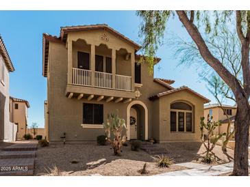 Charming two-story home featuring a quaint balcony and a well-manicured desert landscape at 32405 N 23Rd Ave, Phoenix, AZ 85085