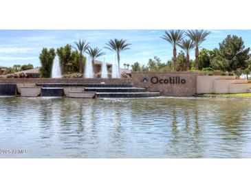 Pond and fountain in the Ocotillo community entrance, with palm trees in the background at 3370 S Ivy Way, Chandler, AZ 85248