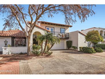 Stunning two-story home featuring a red tile roof, balcony, two car garage, and beautifully landscaped yard at 77 E Missouri Ave # 7, Phoenix, AZ 85012