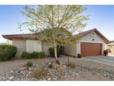Charming single-story home featuring a tile roof, low maintenance desert landscaping, and warm curb appeal at 8354 E Emelita Ave, Mesa, AZ 85208