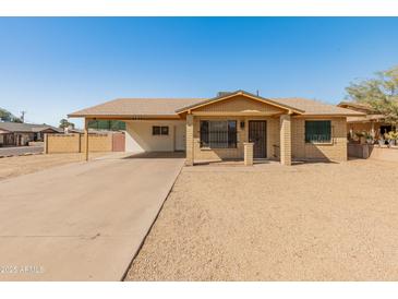 Charming single story home with a covered carport and low maintenance desert landscaping at 8648 N 37Th Ave, Phoenix, AZ 85051