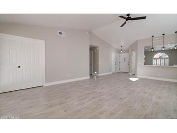 Spacious living room featuring modern flooring and neutral paint, allowing for versatile decorating options at 9437 E Champagne Dr, Sun Lakes, AZ 85248