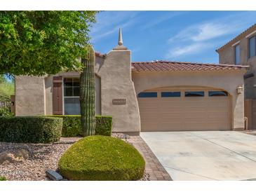 Charming single-story home with a desert landscape and a spacious two-car garage at 12098 W Lone Tree Trl, Peoria, AZ 85383