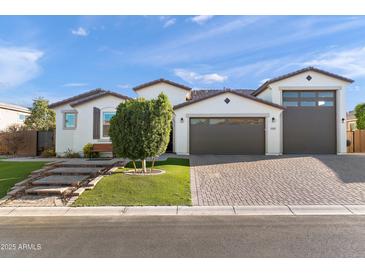 Beautiful single-Gathering home featuring a three-car garage and low-maintenance desert landscaping at 12539 W Tuckey Ln, Glendale, AZ 85307